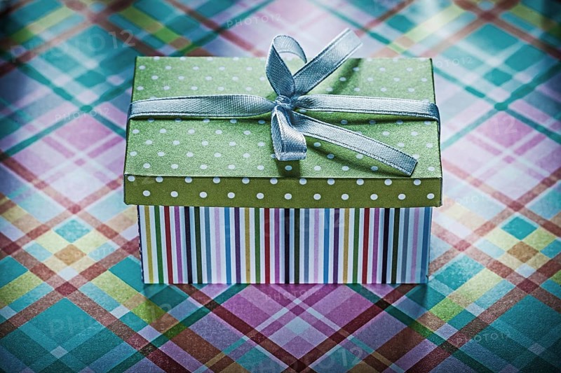 Present in cardboard box on checked fabric holidays concept