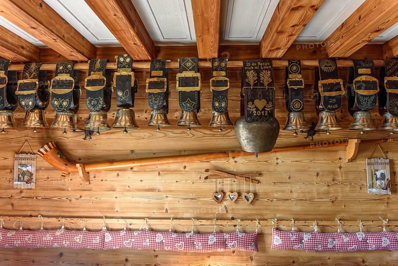 Cow bells displayed in restaurant of mountain farm. Vosges, Alsace, France, Europe