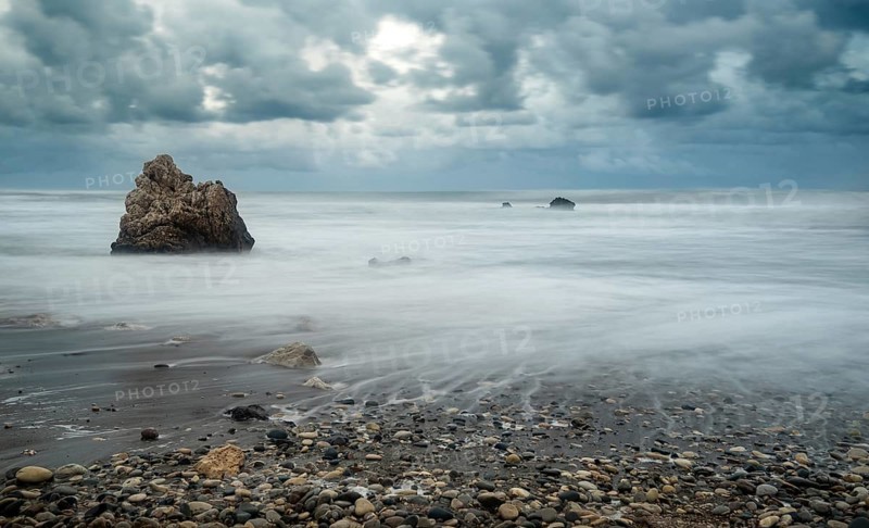 Seascape with windy waves during storm weather at the rocky coastal area of the Rock of Aphrodite in Paphos area, Cyprus. Longexposure Photography