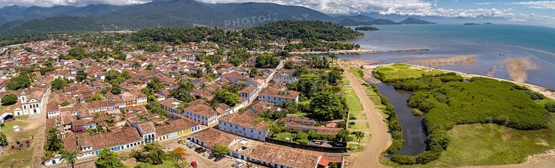 Panoramic aerial view to historic town Paraty with green mountains and sea in background on a sunny day, Unesco World Heritage, Brazil, South America