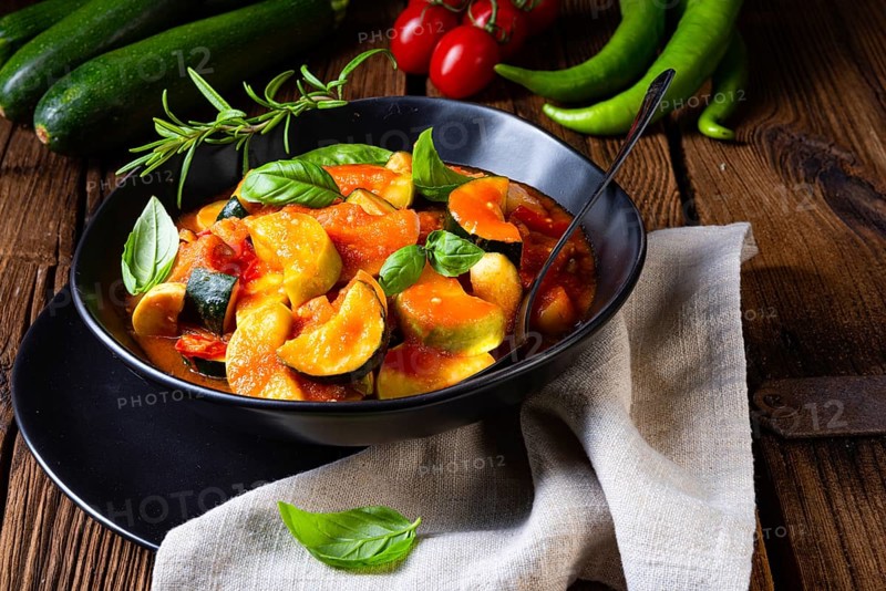 Vegetarian courgette ratatouille with tomato sauce and herbs