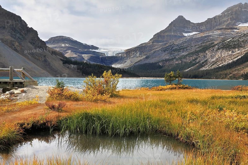 Shining azure surface of the lake. Early autumn in the Rocky Mountains of Canada