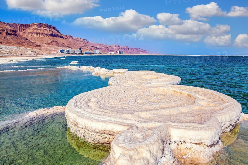 Evaporated salt forms beautiful, symmetrical crystals on the surface of the water. The saltiest lake in the world. The drainless salt lake in the Middle East. Dead Sea. Israel