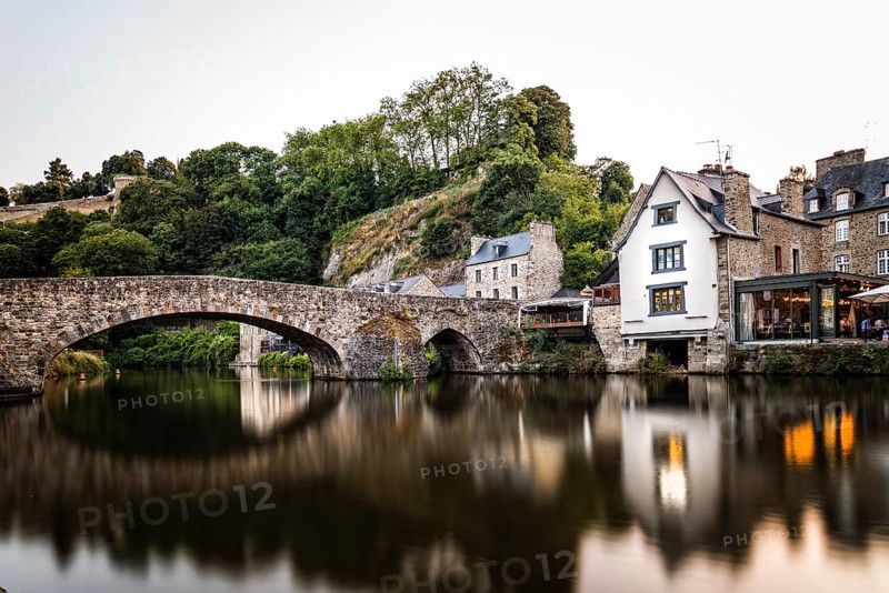 View of the medieval vridge over river Rance and the harbour of the city of Dinan, French Brittany. Long exposure