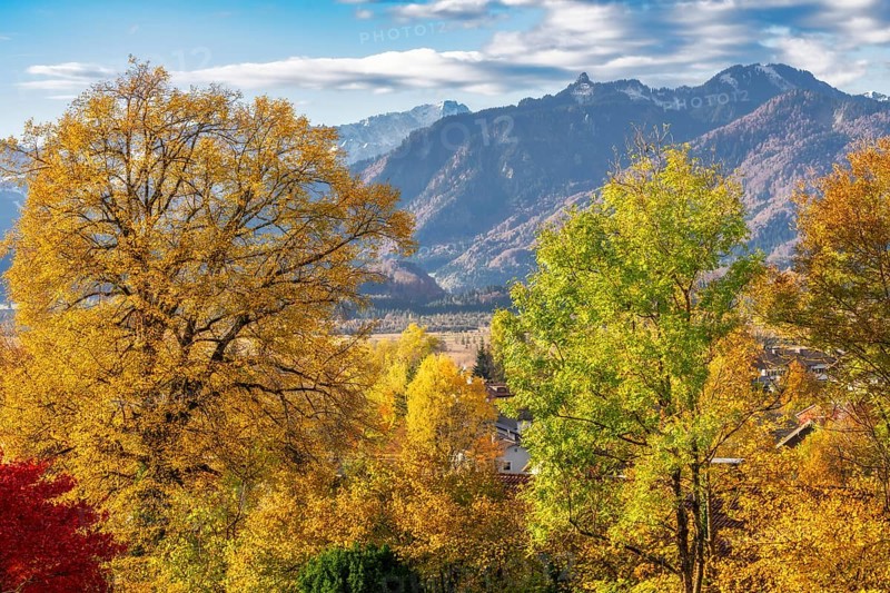 Autumn scenic with the view from the town Murnau to the alps