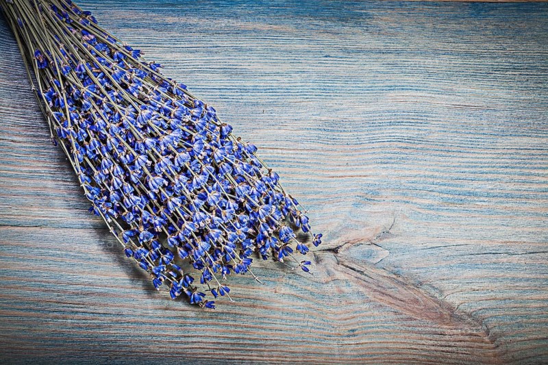 Sheaf of dry violet scented lavender on wooden board healthcare concept