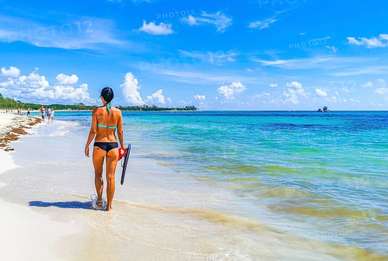 Sexy lady girl pretty woman walks on the tropical mexican beach with turquoise clear water on Playa 88 and Punta Esmeralda in Playa del Carmen Mexico