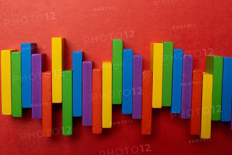 Colorful dominoes. Rainbow colored chain reaction