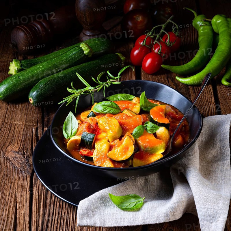 Vegetarian courgette ratatouille with tomato sauce and herbs