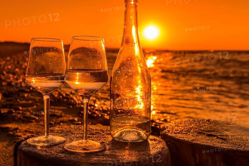 Wine on the baltic sea beach at sunset