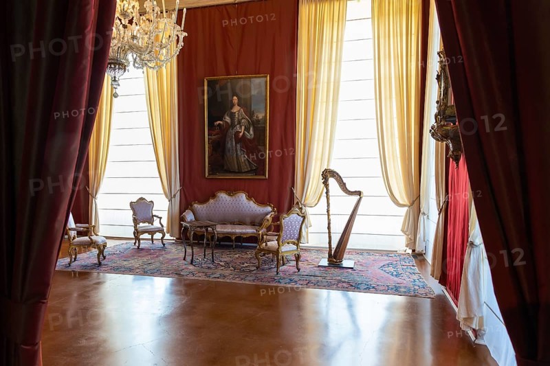Venaria Reale, Italy, February 2023: luxury interior, old Royal Palace. Perspective with harp, window and baroque decoration, Europe