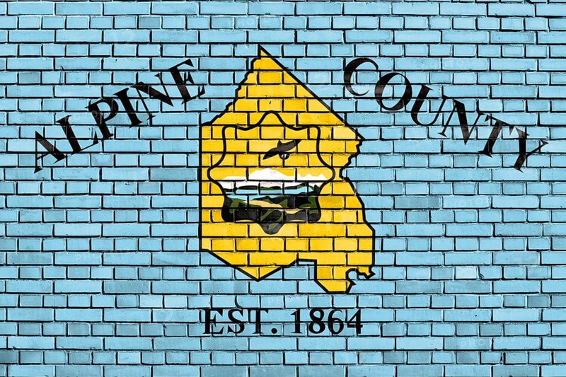 Flag of Alpine County, California painted on brick wall