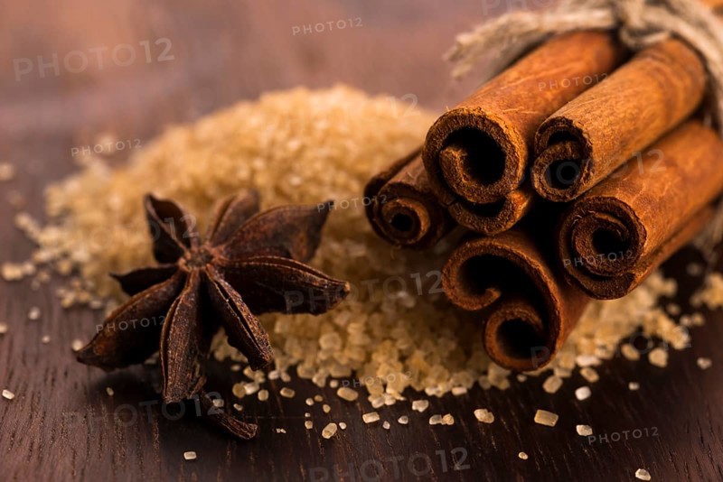 Cinnamon sticks with pure cane brown sugar on wood background