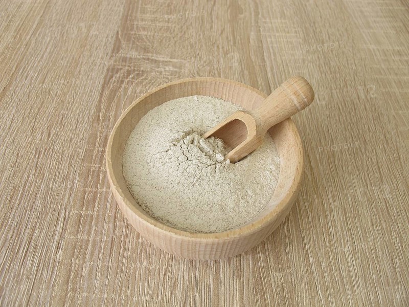 Banana flour made from green plantains in a wooden bowl