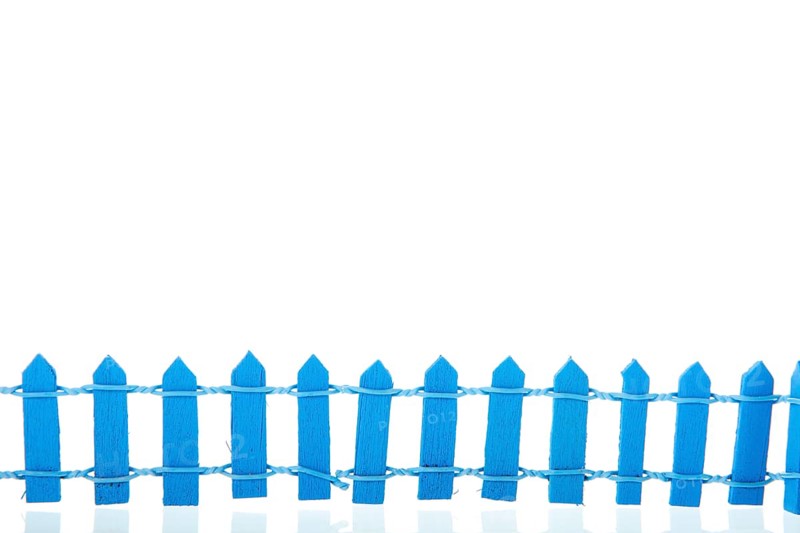 Miniature blue fence isolated over white background