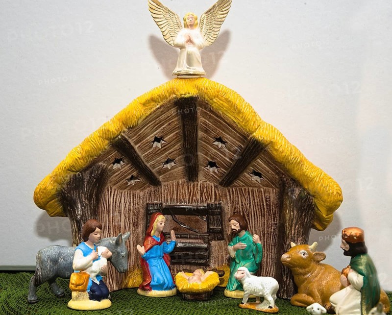 Nativity scene with painted figures of Christmas in the stable - close-up