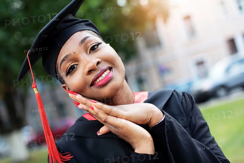 Belarus, the city of Gomil, 01 July 2020. Street in the city. African American in graduation hat, Europe