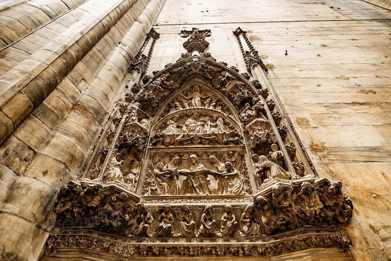 Relief on a religious theme on the wall in the Duomo. Milan, Italy.
