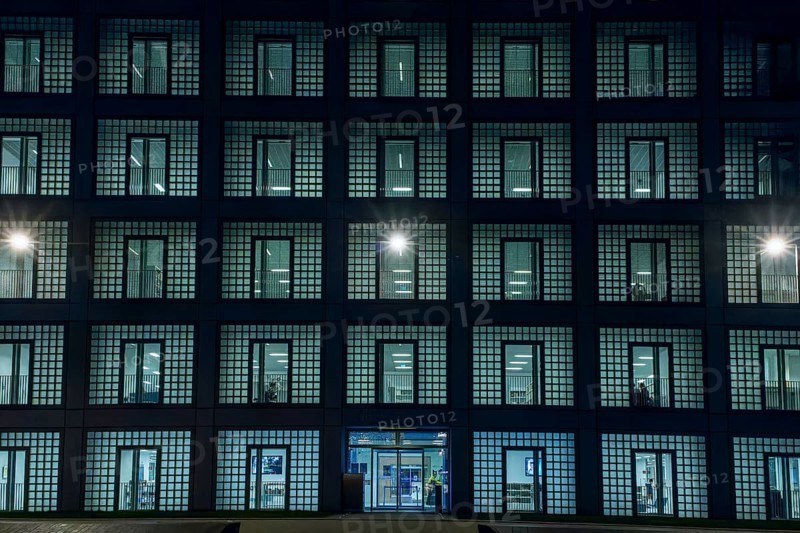 Night shot of the façade with entrance door and countless windows of the cube-shaped city library on Mailänder Platz by architect Prof. Eun Young Yi, Stuttgart, Baden-Württemberg, Germany, Europe