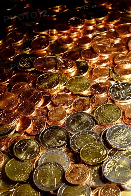 Euro coins of all denominations fill the motif. Portrait format. Euros of all coin values fill in the hole picture. Vertical format