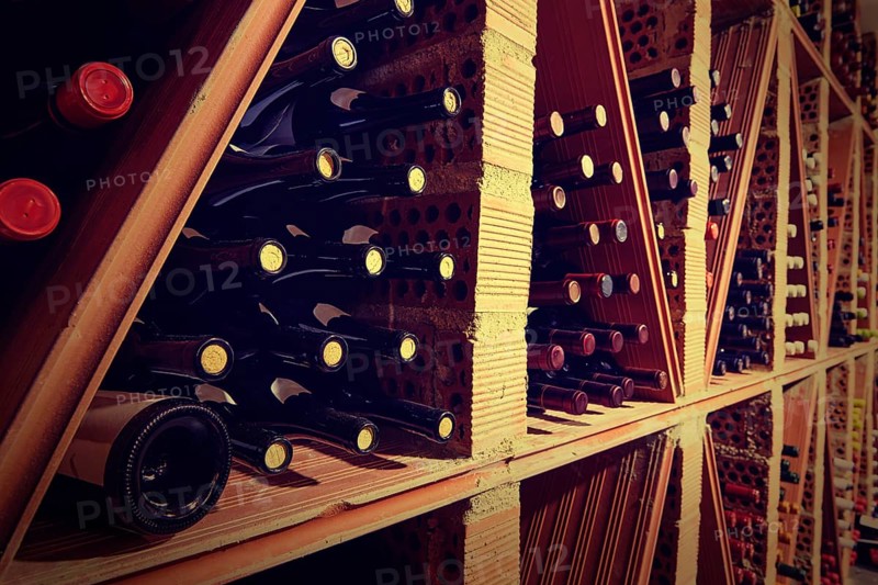 Wine Cellar from Mediterranean with bottles stacked in rows