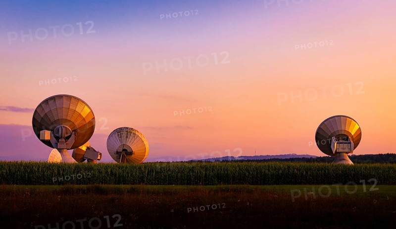 Large parabolic antenna at dusk