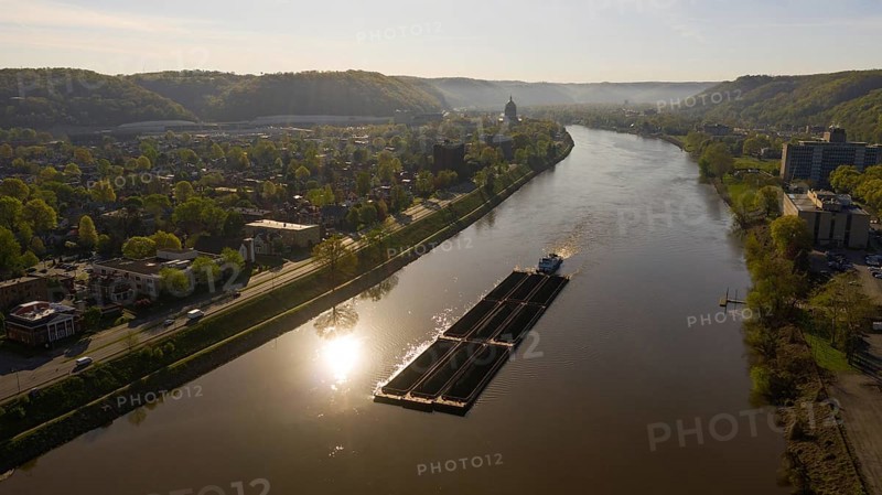 Charleston West Virgina ia an active seaport here a barge moves coal around