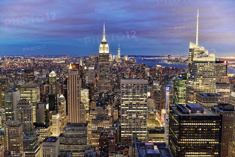 Rockefeller Center observation deck, panoramic view of the dense New York City skyline, lights of the New York metropolis illuminate the city under a purple night sky, Manhattan, New York City, New York, USA, North America