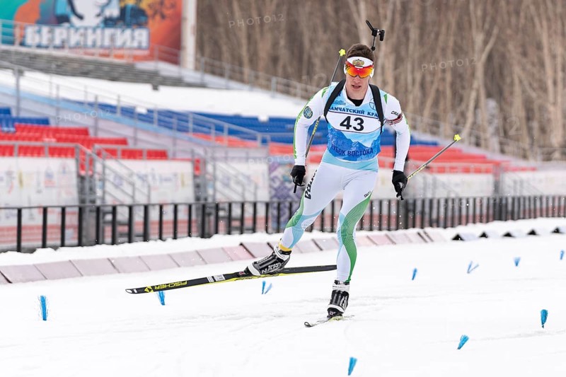 Sportsman biathlete Zlobin Vladislav Khanty-Mansiysk skiing on distance biathlon stadium. Open regional youth biathlon competitions East Cup. Kamchatka Peninsula, Russian Far East, April 12, 2019