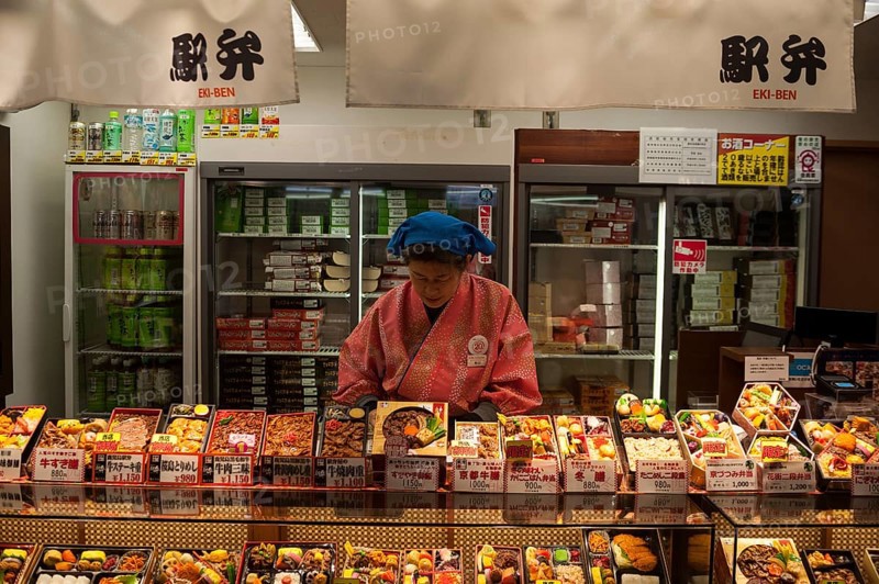 23 Dec 2017, Kyoto, Japan, Asia, A woman sells ready meals and drinks in a train station kiosk in Kyoto, Asia
