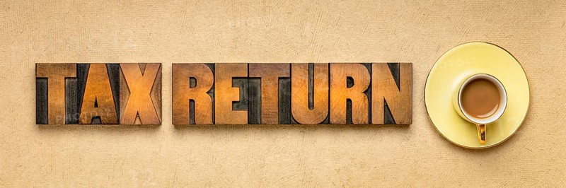 Tax return banner - word abstract in vintage letterpress printing blocks against textured paper with a cup of coffee, business financial concept