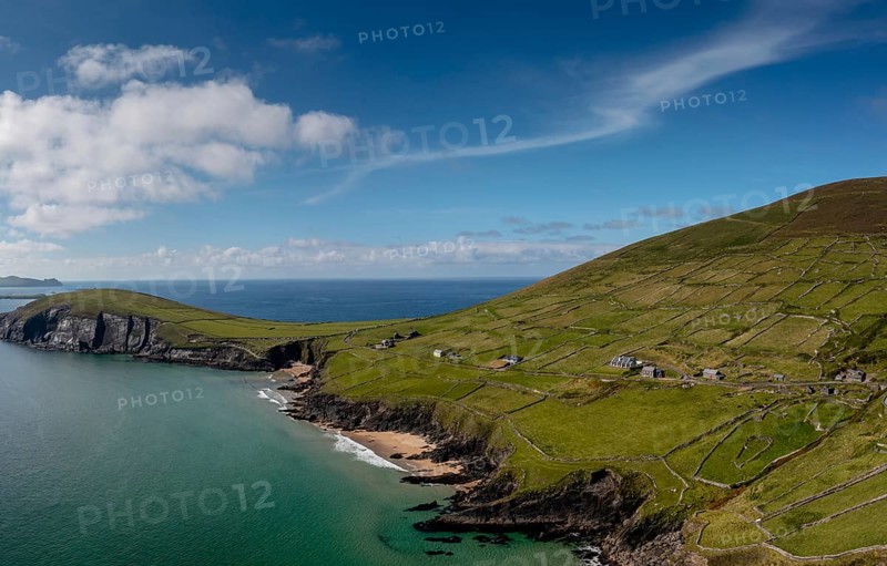 Landscape view of the turquoise waters and golden sand beach at Slea Head on the Dingle Peninsula of County Kerry in western Ireland