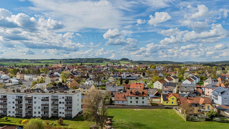 Urban landscape with varied roofs and green surroundings under a changing sky, Mitterteich, Upper Palatinate, Bavaria, Germany, Europe