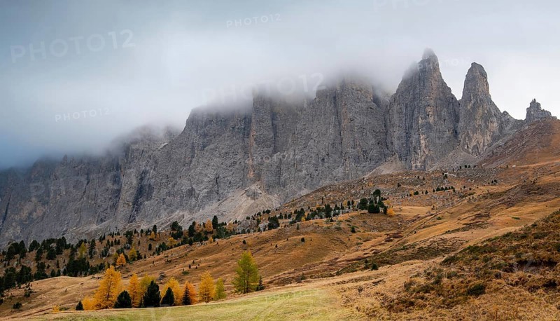 Mountain landscape of dolomites covered with fog Italian alps in autumn. Nature scenery Italy. Passo Sella South tyrol