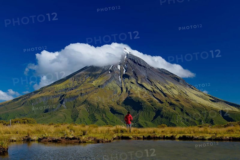 A man in front of Mount Taranaki in New Plymouth, New Zealand, Oceania