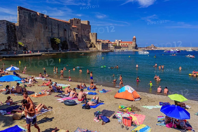 People having fun on the beach in summer in Collioure, France, Europe