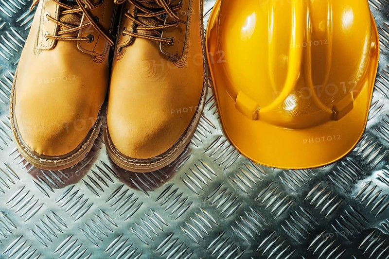 Protective boots hard hat on fluted metal sheet