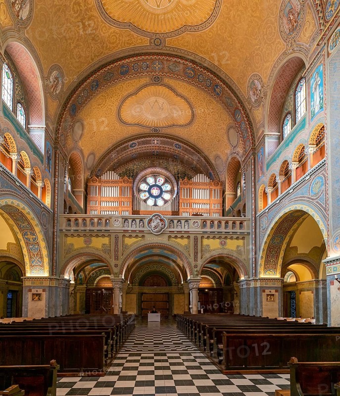 Szeged, Hungary, 14 October, 2022: view of the central nave with wooden pews and the church organ inside the Szeged Cathedral, Europe
