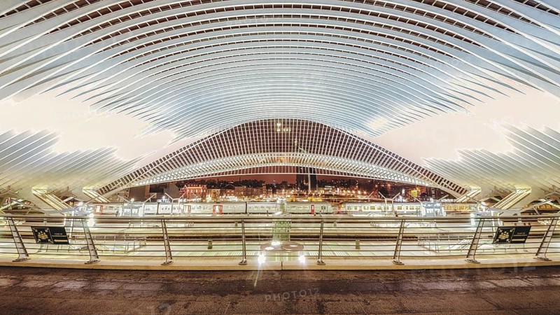 Wide, illuminated station interior at night, characterised by modern structures, Liège-Guillemins station, Liège-Guillemins, Belgium, Europe