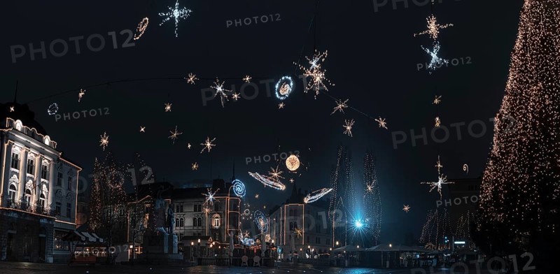 Panorama with the city center of Ljubljana, capital of Slovenia, decorated with Christmas lights, on a cold night of December