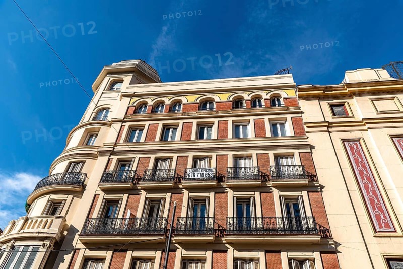 Madrid, Spain, November 1, 2020: Old residential building with iron balconies in the downtown of Madrid. Low angle view against sky, Europe