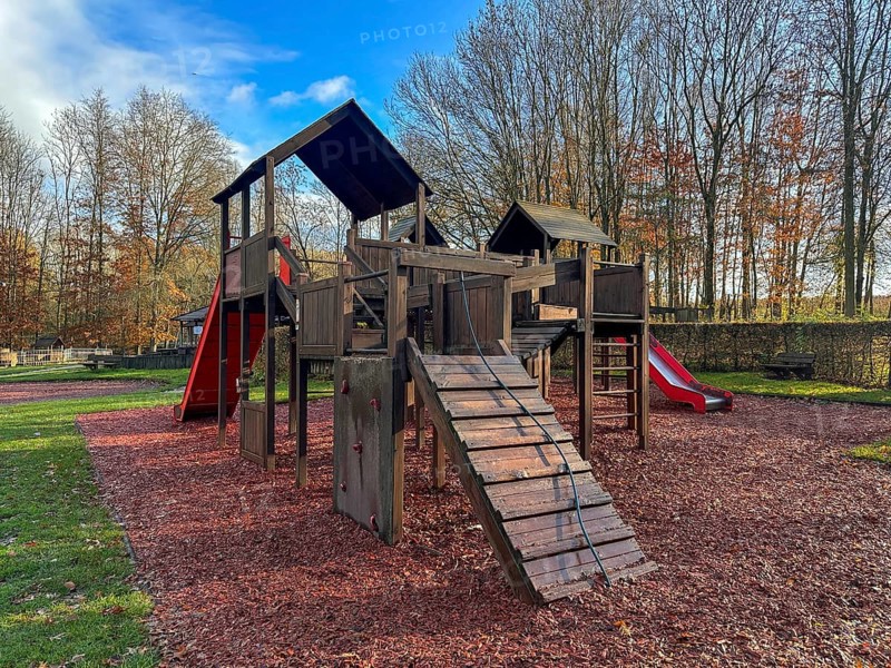 Colorful playground with climbing stairs and slides on yard in the park