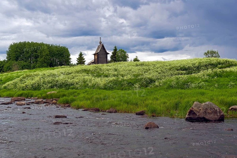 Wooden chapel on the banks of the river Keret. At this point the Keret River flows into the White Sea. Karelia, Russia, end of June, Europe