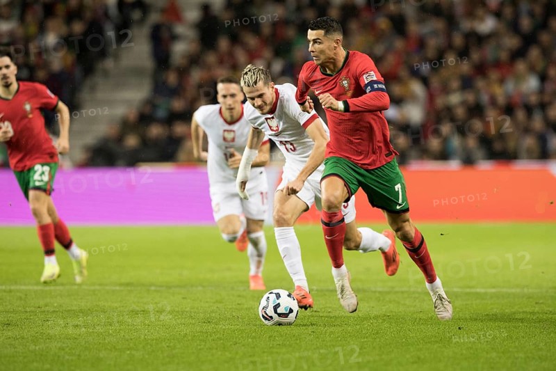 Football match, captain Cristiano RONALDO CR7 Portugal right on the ball runs towards the opponent's penalty area with a concentrated look ahead, Jakub KAMINSKI 13 Poland and Dominik MARCZUK 19 Poland follow him, on the left outside VITINHA Portugal can be seen slightly obscured, sequence 3, Estadio do Dragao, Porto, Portugal, Europe