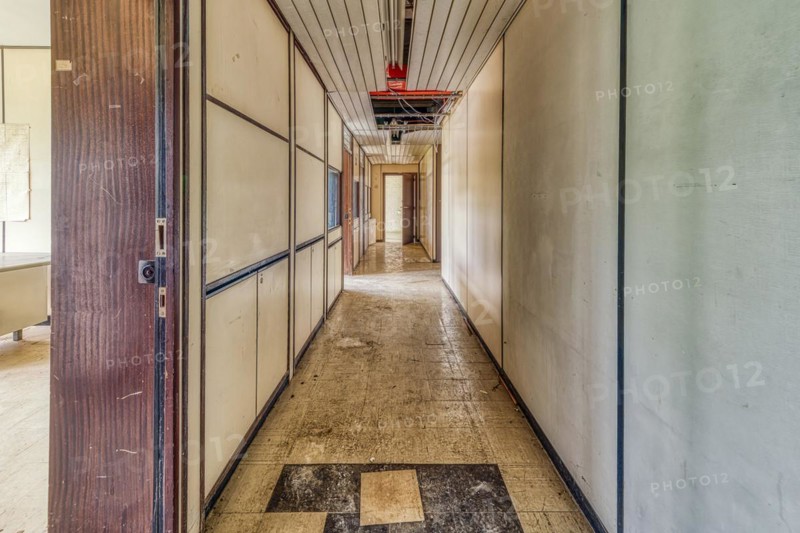 A long, empty corridor with closed doors on both sides and a tiled floor, Institute of Molecular Biology, Lost Place, Sint-Genesius-Rode, Province of Flemish Brabant, Belgium, Europe