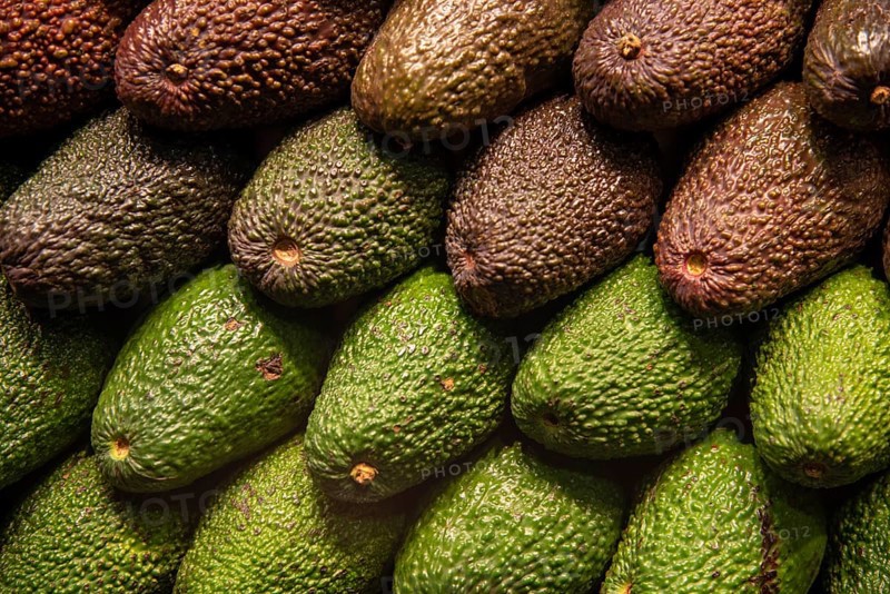 Group of fresh avocado fruits on a fruit market for a healthy lifestyle