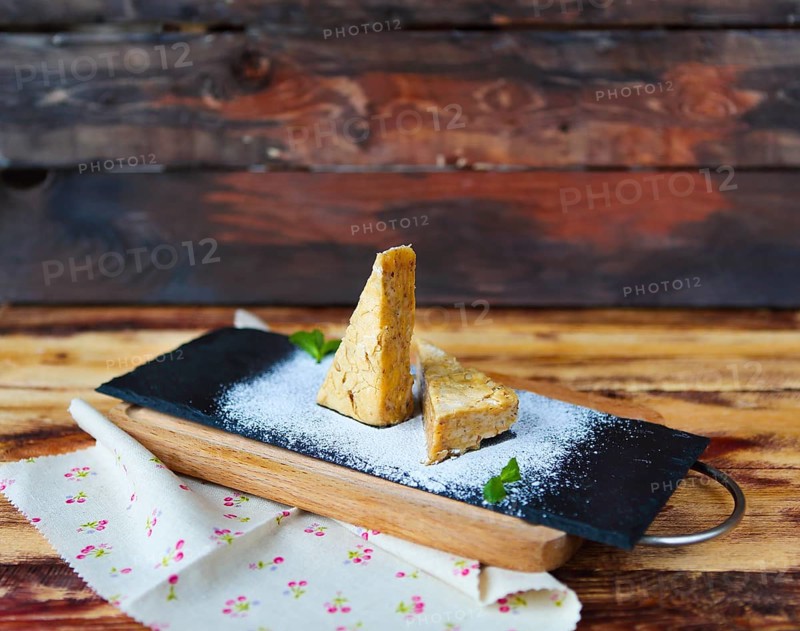 Traditional Hungarian Esterhazy cake on a wooden background