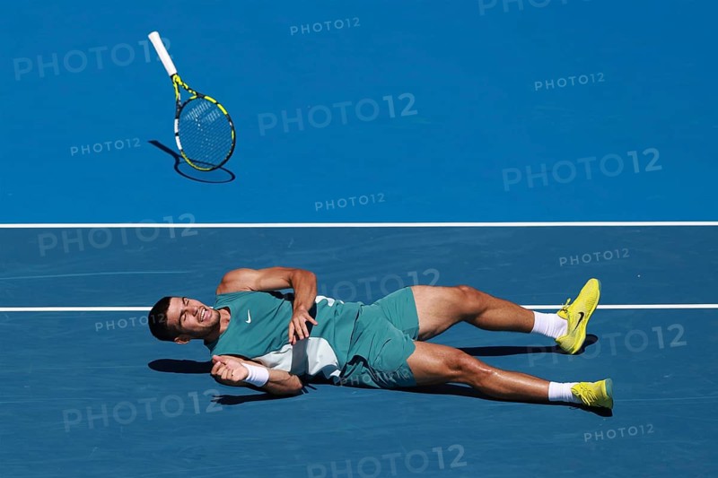 Spanish tennis player Carlos Alcaraz (ESP) diving for forehand shot and falling to the ground at the Australian Open 2025 tournament, Melbourne Park, Melbourne, Victoria, Australia, Oceania