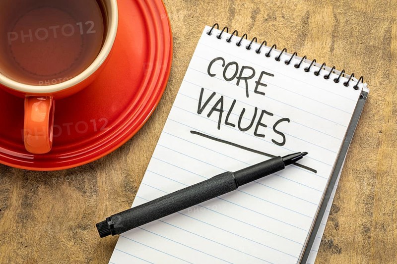 Core values - handwriting in a spiral notebook with a cup of tea
