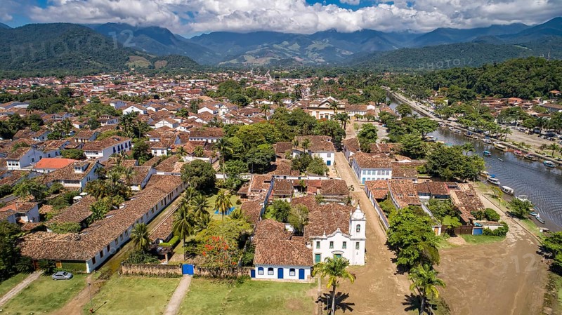 Aerial view to historic town Paraty with tidal river and green mountains in background on a sunny day, Brazil, Unesco World Heritage, South America